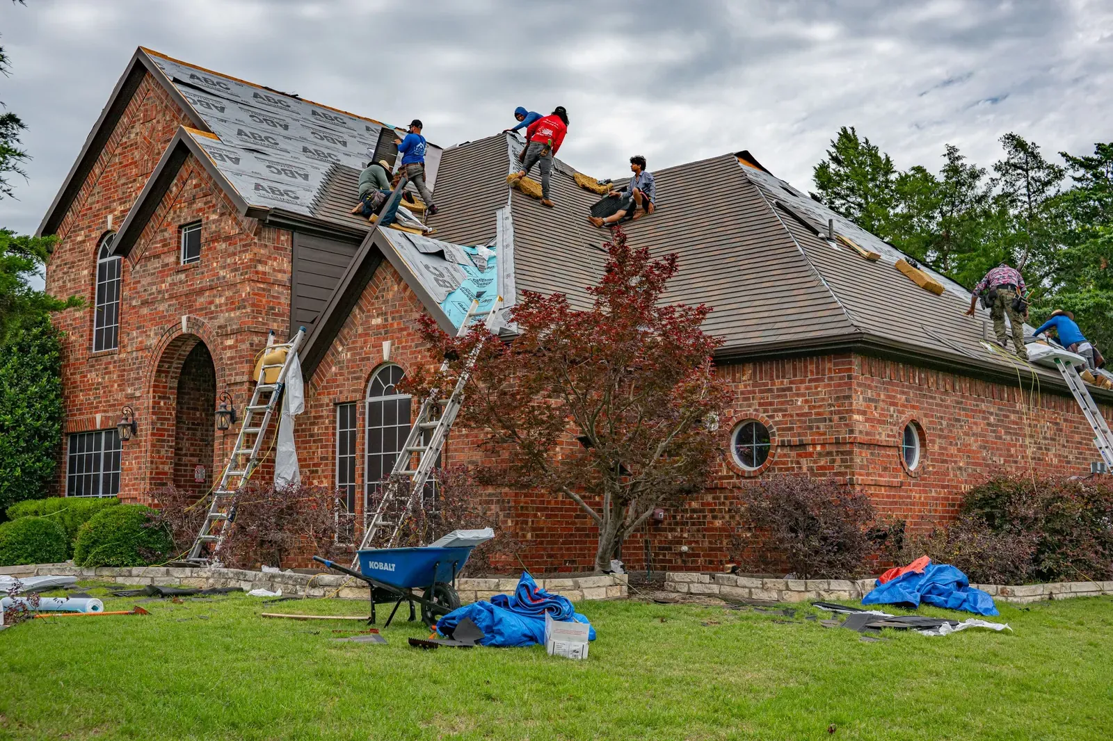 Roofing crew working on a brick home