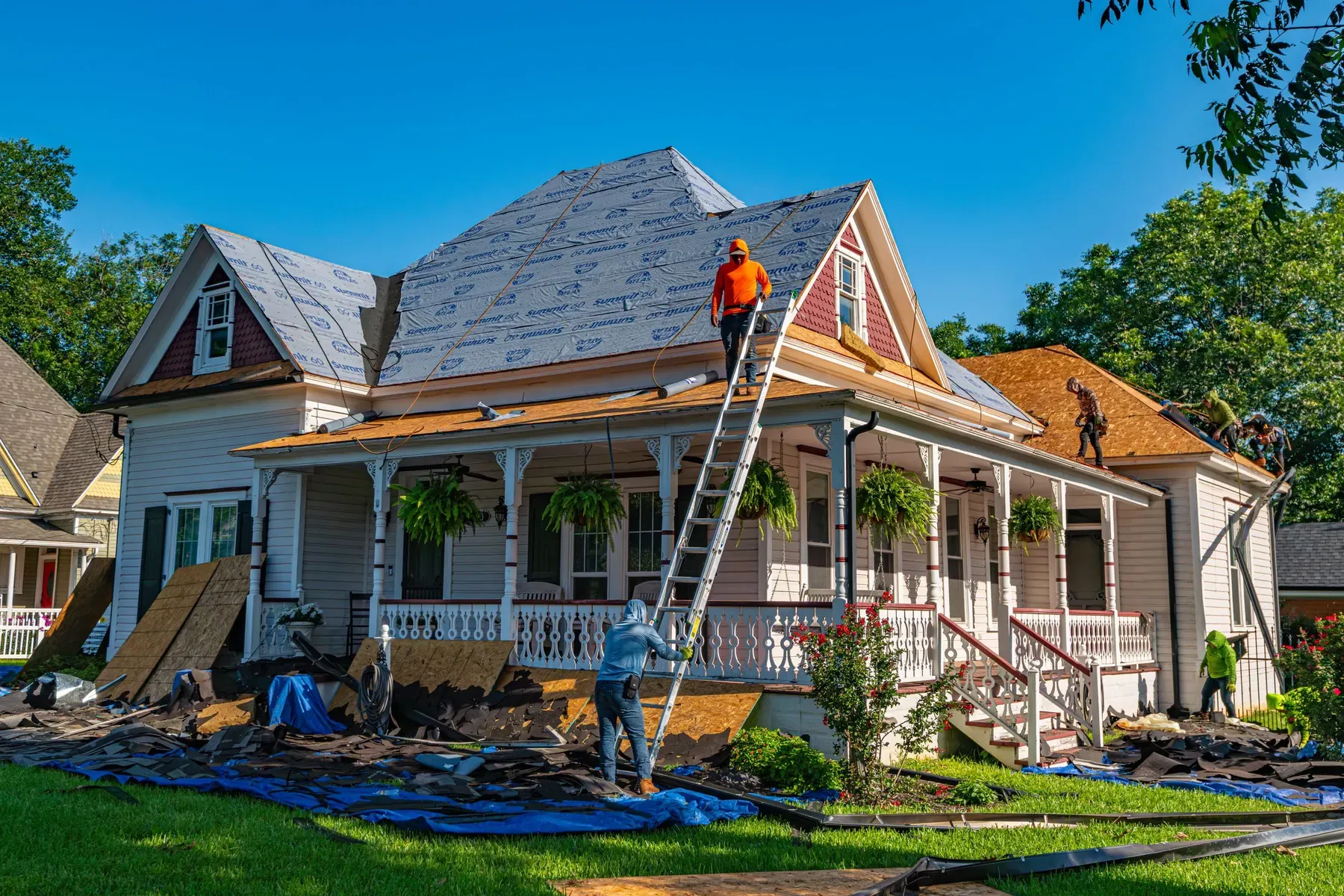 Roofing crew replacing the roof on a historic home